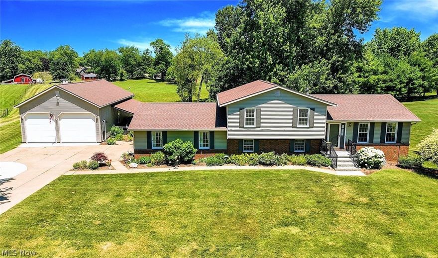 *Four Level Split Meticulously Maintained In Hartville Boasts 1,800 Sq. Ft, 3 Bdrms, 2 Full Bathrms ++ A 6 Car Garage On .85 Acres!! *No Neighbors Directly Behind/Great Location! *AUTO LOVERS -->2 Car Attached Garage PLUS 4 CAR HEATED 1,170 Sq. Ft. Detached Garage W/TALL 10 FT. GARAGE DOOR For Trucks, Boats And More! Heated By Reznor Heating, NEW Industrial Ceiling Fan On Rheostat Controls, 12'5" Ceiling, It's Own H20 Tank, Gas For Stove Etc, Double Windows, Electric = Nice!! *No Maintenance DECK W/Black Accent Railing *Covered PATIO W/Lighting On The Side Of Garage W/NEW $11k SPA HOT TUB -Custom Easy Pull Cover, Stairway To Enjoy Cool Evenings @ Your New Home!! *Small Shed/Playhouse *Upgraded Landscaping *Stamped Concrete Front Entrance *Walk In To A Foyer W/New Scratch & Impact Resistant COREtec Pro Series Luxury Rustic Plank Flooring Featuring A Denser & More Rigid Core Layer To Last For Years *Arched Entryway To Formal Dining W/6 Light Chandelier & Triple Windows For Natural Light-