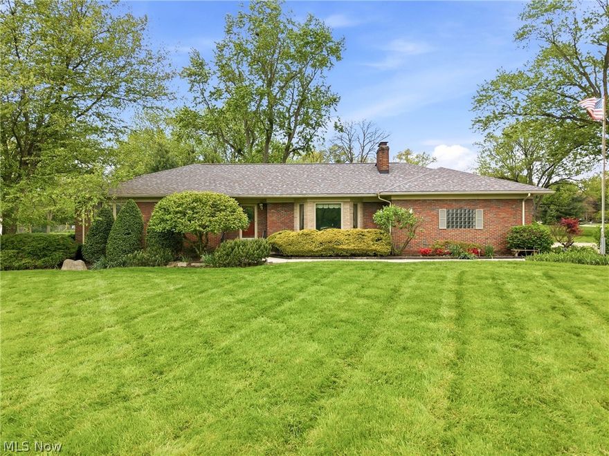 Welcome home to this spacious 3-bedroom, 1.5-bath brick ranch situated on a beautifully maintained 1.4-acre corner lot in the desirable Howland Local School District. Offering 2,056 square feet of first floor living space plus a generously finished basement that nearly doubles the home's usable area, this property combines comfort, character, and functionality throughout. 
The updated kitchen features ceramic tile flooring, rich maple cabinetry and woodwork, and a stunning stained-glass light fixture that adds warmth and charm. The inviting living spaces include a cozy fireplace, an all-weather sunroom, spacious cedar closet and Pella windows with built-in blinds for style and efficiency.
The finished lower level adds more than 1,500 square feet to the home and is ideal for entertaining, play area, or additional living space with a large rec room, built-in wet bar, wood burning fireplace, laundry chute, huge laundry room, fruit cellar, and abundant storage. The home also features a jacuzzi tub, an eclectic retro half bath full of personality, and fresh paint in the attached 2-car garage which is equipped with electric and water.  Additional storage area can be found in the attic, complete with wooden floor.
Outdoor amenities include a private deck, circular driveway, sprinkler system, storage shed complete with electric, and mature outdoor space perfect for relaxing or entertaining. Additional updates include a 5-year-old roof.  City water tap  is available if desired.
This well-maintained ranch is immediately available, move-in ready and offers timeless character, generous living space, and a peaceful setting with room to enjoy both inside and out.