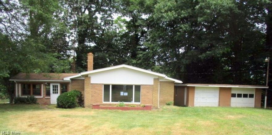 Solid Brick Ranch situated on a 5.94 acre private setting abutting Little Beaver Creek, featuring a formal dining room and 2 car garage.