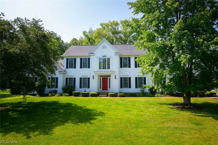 This well maintained Colonial in Hudson offers 4 bedrooms, 2.5 baths and approximately 4200 SF of living space.  The eat-in kitchen has granite countertops, SS appliances, desk, and French doors that lead to the private backyard and deck.  The family room has a wood-burning fireplace, a vaulted ceiling and a large picture window.  Hardwood floors in the kitchen, foyer, and back hall.  The formal dining room features a beautiful chandelier, chair and crown moldings.  First floor living room and office.  Laundry room and half bath conveniently located on the first floor.  The second floor has a large master suite with a walk-in closet, and an ensuite glamour bathroom complete with dual sinks, separate tub and stand up shower.  Three additional bedrooms and full bath complete the second floor.  Partially finished full basement with plenty of room for storage.  Three car garage and a basketball hoop. Private wooded backyard. Carpet and freshly painted rooms throughout the home.