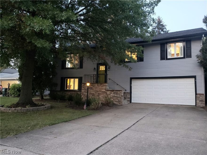 Live like your on vacation in the private lake community of Aurora Shores! Rare 2450sqft bi-level! Updated kit in '21 with updated cabinets, hardware, sink, counters, back splash, & new disposal. New hardwood flrs installed '17. New carpet installed '20 (except lower level family rm). Remodeled 1st fl ba in '19 with new tub, tiled shower, hardware, fixtures, vanity, sink top, faucet, lighting, flooring, & added pocket door. Lower level family rm has brick front wood burning fireplace. "Mudroom" hallway has a door that leads to a large storage area under the stairs & foyer entry. Master bdrm had new floors installed in '20 & added a new closet system. Converted 4th bdrm in lower level to an entertaining/bar space in '17 by opening rm to family rm & hallway & adding bar space in existing closet area. Sliding glass doors lead to patio. (Seller happy to convert back to bdrm if buyer would like). Remodeled lower level bath in '17 with new floors, vanity, sink top, faucet, toilet, lighting,