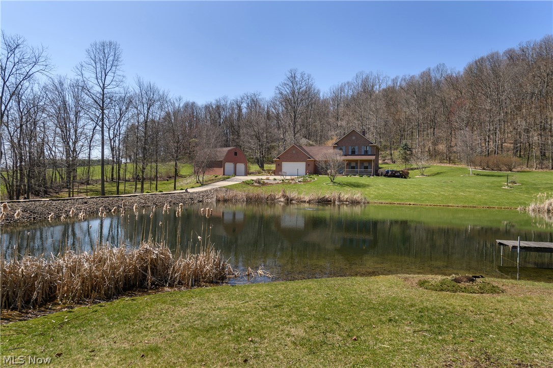 TRULY A RUSTIC RETREAT NESTLED ON 5.9 ACRES with beautiful stocked pond with dock. Total of 3 stories - 1st floor has kitchen with Mullett cabinets opening to a great room. It leads to a great deck and top of the line hot tub. 1st floor laundry, full bath and office, LR & DR round out the living on this floor. 3 BR 1 BA on 2nd floor. Finished lower level adds approx. another 500 sq. ft. 24 x 32 barn w/loft, 3 car oversized garage with stone flooring. This timeless beauty is approached by fantastic cement entrance. MUST SEE!