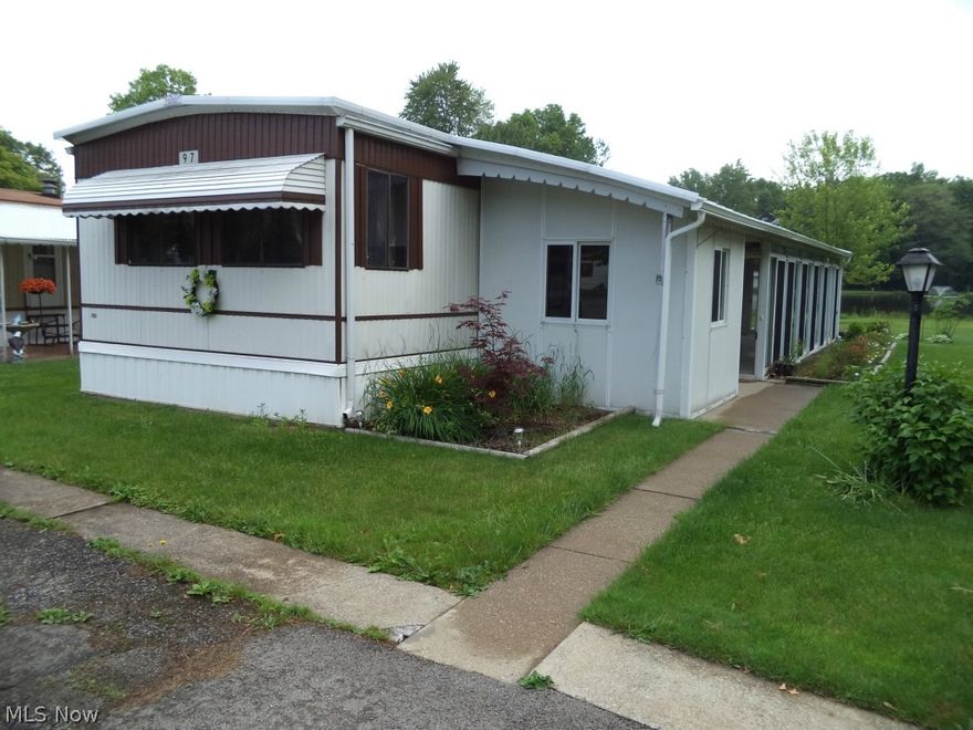 2 bedroom 1 bath 1983 Rochester manufactured home (14 x 70) w/large enclosed porch w/new sub floor & carpeting w/sliding doors to exterior & all new vertical blinds (2014). Home has many updates 2013-2014 including new Cacraft roof (cost was $8000+), H2O tank, carpet, flooring kitchen & bath, painted interior, range, refrigerator, professionally landscaped & custom swing overlooking lake/pond. There is also an attached shed for storage. View of lake/pond is a delight for you to enjoy.