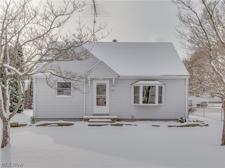 Adorable cape cod in Barberton! This 3 bedroom home offers a large eat-in kitchen with new plank flooring and paint throughout, plus a first floor bedroom. The living room has hardwood floors, charming built-in shelving, and windows adding plenty of natural light. A two car detached garage, plus you can enjoy your privacy on the covered concrete patio or use it for entertaining! Other updates include: countertops (2017) hot water tank (2016) and garage roof (2016).