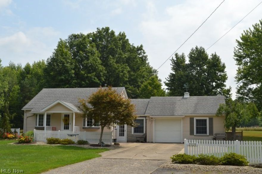 Absolutely breathtaking & perfect! Fantastic location, plenty of room & an amazing park-like back yard w/storage building! This charming ranch style home has everything you've been looking for! A lovely foyer opens into the updated kitchen which features oak cabinets, recessed lighting, stunning hardwood floors, beautiful bay windows & all the appliances. Gorgeous living room w/bay window, 2 ample sized bedrooms & an updated bathroom are sure to please you! A fantastic 12 x 30 enclosed porch w/swing is great for any occasion. Full, walk-out basement w/ceramic tile flooring, washer & dryer included. Other updates include; water softener (2016), well pump & tank (2014), kitchen & bath (2006), electric (1998), roof (1997) & furnace & air (1993). Wonderful home inside & out!