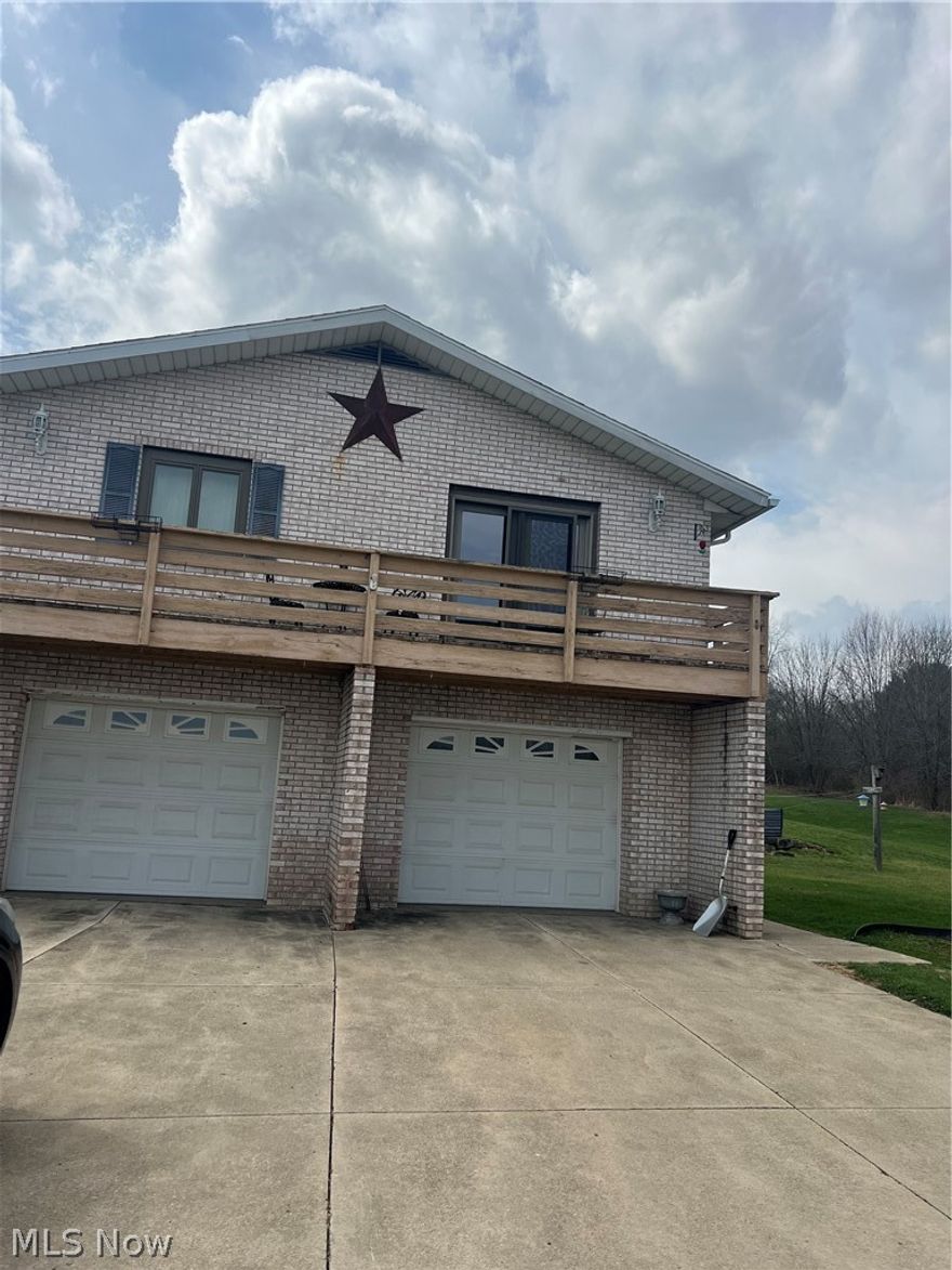 Spacious 4-bedroom, 2.5-bath bi-level home situated on over 2 acres, offering both comfort and room to spread out. The main level features a bright living room, a fully applianced kitchen, and three bedrooms. Sliding doors off the kitchen lead to a raised back deck—perfect for enjoying the peaceful surroundings. The lower level adds even more living space with a cozy rec room complete with a fireplace, an additional bedroom, a dedicated gun room, and a convenient walkout to the back patio. There is also a 2-car attached garage leading into the lower level. Outside, you’ll find a large outbuilding ideal for storage, hobbies, or workshop use. Major updates provide peace of mind, including a new roof, furnace, A/C, and hot water tank—all replaced in 2025. The water softener is just 4 years old. A great opportunity to enjoy country-style living with some modern updates already in place!