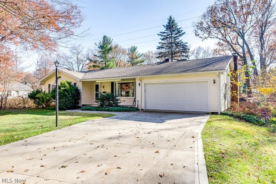 Located in one of Kent's most desirable neighborhoods, this adorable 3BD/2BA ranch home is just minutes from KSU, downtown Kent, Neomed, Routes 43 and 261 and I-76! Nestled on a quiet tree-lined street, this inviting home has a formal entry and Living Room with a large window overlooking the picturesque front yard. The sleeping quarters include three bedrooms all with ample double-door closets, a Full Bath with tub, and the primary bedroom has an en-suite Full Bath with shower. Hardwood floors under carpets in bedrooms. The cheerful and bright eat-in Kitchen has newer wood flooring that extends to the adjacent Dining Room/foyer and opens up to an inviting Family Room with a wood-burning Fireplace. A sliding glass door off the family room takes you to a deck overlooking the flat and private backyard. Downstairs is a partial basement with laundry hook ups and crawl spaces on either side that provide additional storage. An attached two-car garage leads directly into the family room and ha