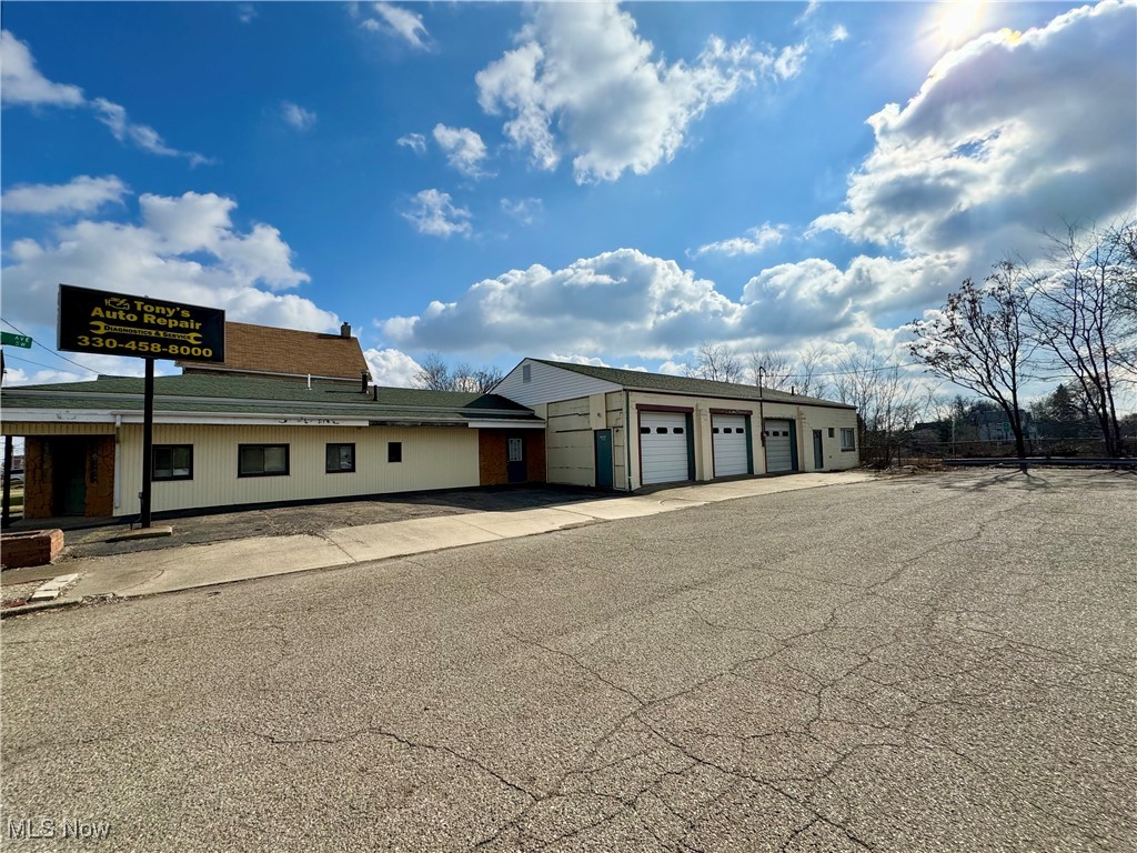 Former auto repair shop that is zoned B-4. Conveniently located with easy access to Rt. 30, Rt. 62 and I-77. Over 5,200 Sq. Ft. of garage/warehouse space and another 1,000 sq. ft. plus of retail/office space. The retail/office area has a bathroom, central air, and full unfinished basement underneath. All areas of the garage/warehouse space are heated with Resnor heaters. Area 1: of the garages has three(3) 10' overhead doors, 3 bays, a well lit detail/paint booth, also plenty of extra storage, one bathroom. Area 2: is 60'x40' garage with one (1) 14' overhead door, heated garage, 4 lifts, and new 80 gallon Ingersall Rand compressor. The lift capacities are as follows; 2 - 6,000 lbs, 1 - 9,000 lbs, and 1 - 12,000 lbs.