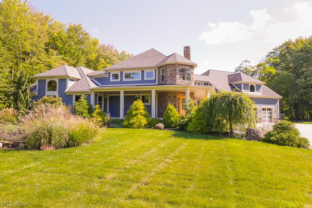This home is an oasis that sits on 1.02 acres & surrounded by 150 acres of wooded land. As you walk through the interior leaded glass front door you take in the open floor plan. All floors are brushed, polished black slate & Patagonian Curupay; a hardwood that turns deeper, darker red with each day. This room offers coffered ceilings of African Mahogany and stone fireplace. Through the mahogany arch you enter the open 700 sqf. gourmet kitchen featuring 2 islands topped with Blue Pearl granite & under mounted Koehler sinks, with bead board cabinets with glass doors above counter level. There is a built-in brass 6 burner Russell Stove, Subzero Refrigerator, dishwasher, and Viking double-oven. The pantry is 50+ sqf. The dining room is off the kitchen & includes a granite topped buffet. Don't miss the retro pot belly stove. The kitchen & dining room lead directly into the sunken great room. Off the great room is a bathroom with walk-in marble shower and countertop. Walk up the mahogany