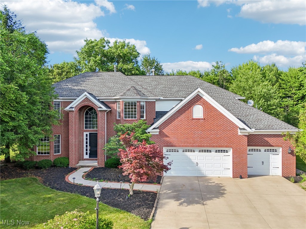 Welcome to this stately brick colonial tucked away on a quiet cul-de-sac in Strongsville’s Waterford Crossing community. Offering over 5,000 square feet of living space, this luxury home is the perfect blank canvas for your personal touch and vision. As you step through the grand two-story foyer, you’re immediately greeted by warmth, elegance & thoughtful design. The home features a great room with a gas fireplace, ideal for both cozy evenings and entertaining. The kitchen is built for culinary creativity with granite countertops, custom cabinetry, a five-burner gas cooktop, double wall ovens, and a spacious center island complete with a prep sink and breakfast bar. A bright and airy sunroom sits just off the kitchen, offering a lovely space to enjoy your morning coffee. On the main level, you’ll also find a formal dining room, a separate living room, a dedicated home office, and a first-floor laundry room for added convenience. The dual staircases add to the grandeur and functionality of the floor plan. Upstairs, the owner’s suite is a retreat with a spacious en-suite bath featuring a soaking tub, walk-in shower, and expansive custom walk-in closet. Each of the additional bedrooms is generously sized and offers either an en-suite or Jack-and-Jill bath, providing comfort and privacy for family or guests. The finished lower level expands your living space with a large recreation room, two bonus rooms that can serve as a gym, hobby room, or guest suite, and a full bathroom—perfect for entertaining, play, or relaxation. Step outside to your private paver patio, the ideal space to unwind with a book, enjoy a picnic, or entertain under the stars. The three-car front-load garage offers not only space for vehicles but also ample storage for bikes, tools, and outdoor gear. Waterford Crossing residents enjoy access to community amenities including a pool, clubhouse, tennis courts & trails. This home offers an exceptional blend of size, quality, and location.