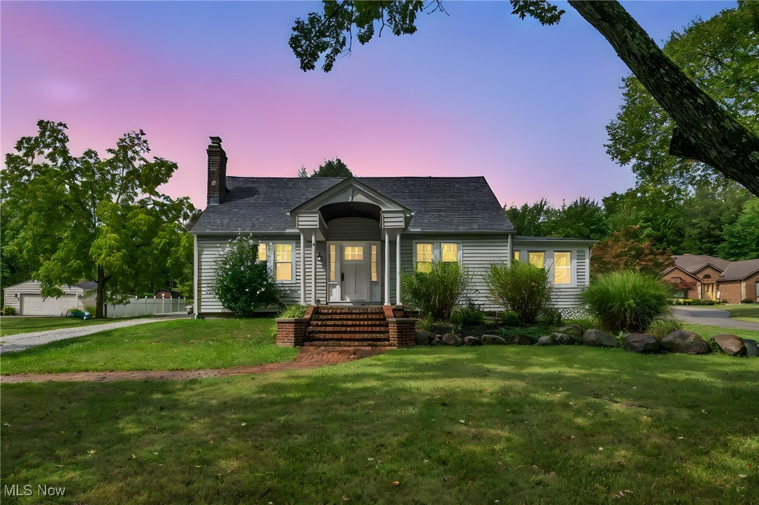 Gorgeous, fully updated North Royalton Cape Cod situated on a little under an acre lot! This stunner of a home is a perfect blend of old charm meets modern updates. Enter the home through the private back entrance and head into the custom kitchen complete with new cabinets, granite countertops, and porcelain flooring. All stainless steel appliances stay! As you head into the living room and dining room you'll love the charm of the arched entryways and intricate details of the gas fireplace combined with the peace of mind and efficiency of newer vinyl windows (2022). French doors lead to a spacious, rustic sitting room with another set of french doors leading to the back deck where you can enjoy tranquility and your favorite beverage. Finishing out the first floor is a first floor primary bedroom and bath with low entry shower and custom tiled shower. Upstairs there is another full bathroom with tub, 2 more bedrooms and tons of storage space - including a beautiful cedar closet! The oversized 24'x34' garage with rear entry service door and parking pad is a dream with unlimited possibilities because it also includes an upstairs loft with electric already ran. All that's waiting are your finishing touches! Roof (2017), HVAC with Aprilaire (2019), HWT (2015)