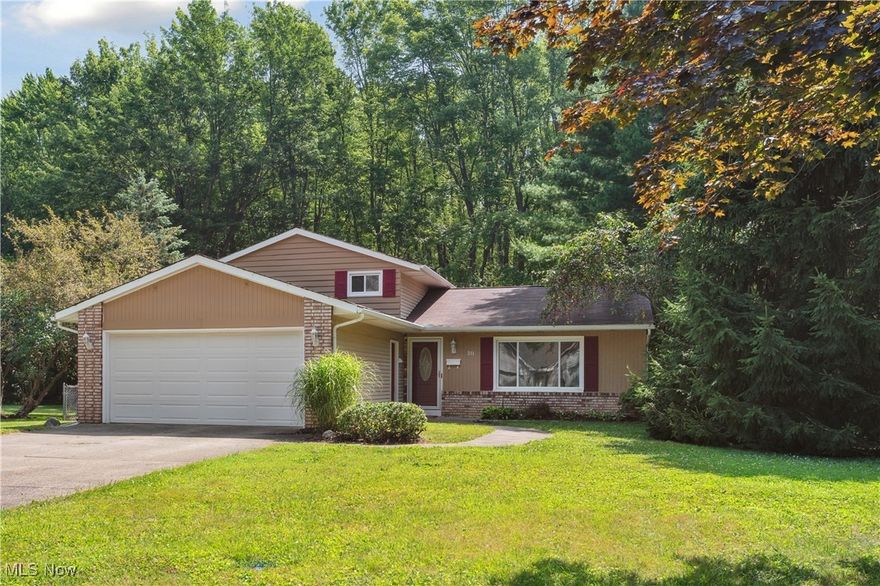 This charming split-level home, tucked away on a dead-end street, is located on a spacious lot offering beauty and privacy with trees and woods along the rear of the property. Conveniently located within walking and biking distance to Oberlin College and downtown, this neighborhood offers a unique path to enjoy the mile-long community trails to the north for your daily walks. An efficient layout begins with entering the main level into an open, bright, and large living room with beautiful views to the front and rear yards, an adjacent dining room and kitchen. The dining room opens to a generous deck, perfect for outdoor gatherings and outdoor dining. The kitchen includes all appliances, has plenty of countertops and cabinet spaces, and is large enough for a small dining nook if you prefer it for everyday meals. The upper-level features three comfortably sized bedrooms and a full bath. Downstairs, you will find a versatile family room with a fireplace to gather around, a hobby space, a utility and laundry room, and a full bath with a walk-in shower – offering room to spread for family and guests. Parking is easy with a front-facing two-car attached garage, a true bonus for Ohio weather! Other desirable features include fresh, neutral paint throughout, neutral new carpet on all carpeted areas, removed and repaired walls where the obsolete electric baseboards were present, central air, bonus tool shed, a fully fenced yard for pets or children, established perennial beds around the house, and a one -year home warranty for the Buyers! Move-in ready -  schedule your virtual or in-person tour today!