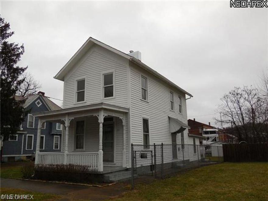 Ready to move in! Newer carpeting, interior painting and much more! Nicely updated kitchen has new oak cabinets, new countertops and new vinyl flooring. Range & refrig included! Living room has vey pretty tile around the ornamental fireplace. New hot water tank. Completely fenced yard. Alley access to garage in rear. Home has nice covered porches, both front and back!