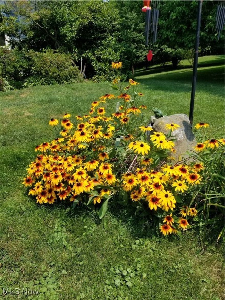 Don't miss this one!    One owner, Ranch style home on 2.2 acres overlooking Nimisila Reservoir. 
 Private, peaceful setting surrounded by nature with beautiful views throughout.  Large, lower walkout level including a 28' x 28' solid concrete garage leading to a huge concrete drive with extra parking......perfect for a boat or RV.  This well-kept home features a custom oak kitchen, newer roof (2024), landscaped beds (2024) & updated vinyl windows and siding.  Hardwood flooring under carpet on 1st level.  Tons of storage in the lower workshop level, perfect for the handyman or craft person.
Call for your private viewing today!