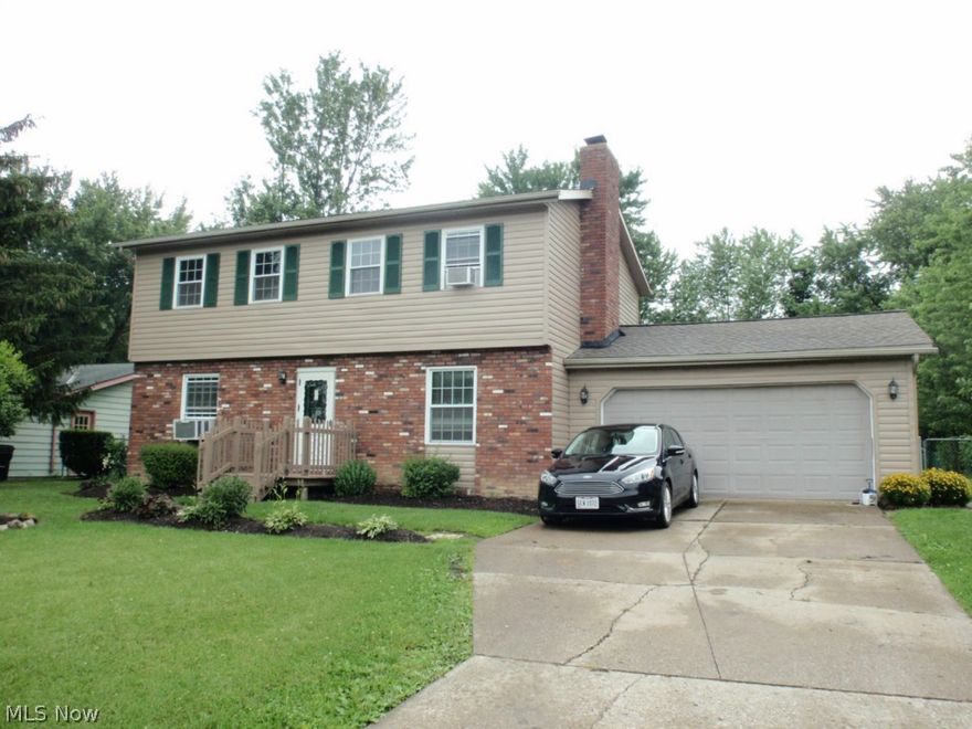 Brick and vinyl sided, center hall colonial.  Country sized kitchen features island, soft close pull out drawers for convvenience  and ceramic tile flooring.  Patio door off eating area to rear deck 24x21 and deep, fenced yard.  Full basement has gas space heater and could be finished into rec room or office.  First floor half bath and first floor laundry.  Lamiate flooring in living and formal dining rooms; dining room has woodburning stove insert.  Lots of natural light and all large sized rooms.