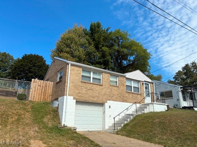 Weirton Heights – Affordable Opportunity! Whether you’re looking for a home of your own or an addition to your investment portfolio, this property is a smart choice. Conveniently located within walking distance of a shopping plaza and just minutes from Rt. 22 with easy access to Pittsburgh. This 2-bedroom brick raised ranch offers a living room, dining room, and an equipped kitchen with new laminate flooring. The partially finished recreation room provides extra living space, while the 1-car garage and partially fenced yard add function and value. Don’t miss out on this opportunity! Call today—or reach out to your favorite agent—to schedule a showing before it’s gone!
