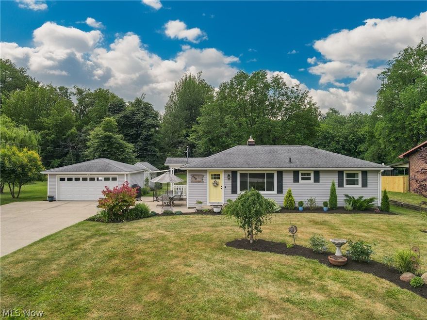 Welcome to 490 Perry! This revitalized 3 bedroom ranch in Tallmadge sits on a picturesque and serene 1.19 acres, and boasts many upgrades both inside and out.  The location is a perfect blend of convenience and nature, as it is close to shopping, but also hiking trails and abundant wildlife. Enter the new front door and you will immediately notice how meticulously this home has been decorated and cared for. In addition to the beautiful wood flooring and natural light in the living room, there is clean paint throughout the home and the crisp look of all new interior doors. The updated eat-in kitchen impresses with newer flooring in addition to appliances and cabinets, which were installed in 2023. A refurbished bathroom, 3 bedrooms and living room complete the main the floor. Downstairs, the spacious full basement hosts an additional 340 square feet of area that could easily be finished by adding carpet. This is a walk-out basement, where the door and steps lead to the backyard. Also in the basement is the furnace which was replaced in 2023 and the 2-year-old electric panel. The air conditioning is newer too, having been replaced in 2022.  Once outside, at the back of the large, paved driveway, is the 2-car detached garage with a new door, opener and repaved floor. Behind the garage a gardener's dream unfolds as you come to a green house, complete with rain barrel and well to allow for easy watering. The shed, also behind the garage, has been re-sided and has a patio-like area tucked away in the corner of it and the greenhouse. The amazing property continues as a beautiful deck sits back in the yard between 2 mature trees, allowing for shade and a place to relax.  Come and envision the possibilities at this move-in ready gem nestled in the heart of Tallmadge.