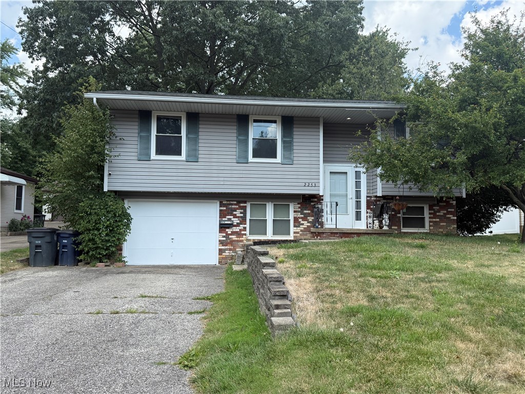 This home offers four bedrooms and two full bathrooms across two levels. The main level includes three bedrooms, a living room, dining room, and kitchen. The lower level features a family room, one bedroom, two updated full bathrooms , laundry room, and workshop. Interior finishes include carpet and vinyl flooring. Appliances that remain with the home include CO/smoke detector, dishwasher, , garbage disposal, wall oven, range, refrigerator and smoke detector. The exterior offers vinyl siding with brick accents, a deck, and a 0.19-acre lot enclosed by a beautiful vinyl privacy fence. Windows replaced (2017) Parking includes a one-car attached garage with electric, drain, and paved driveway. Utilities include public water and public sewer. Heating is forced air gas, and central air. Walking distance from Akron City School District.