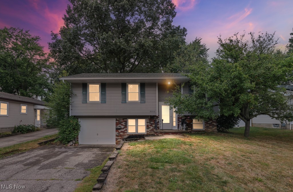 This home offers four bedrooms and two full bathrooms across two levels. The main level includes three bedrooms, a living room, dining room, and kitchen. The lower level features a family room, one bedroom, two updated full bathrooms , laundry room, and workshop. Interior finishes include carpet and vinyl flooring. Appliances that remain with the home include CO/smoke detector, dishwasher, , garbage disposal, wall oven, range, refrigerator and smoke detector. The exterior offers vinyl siding with brick accents, a deck, and a 0.19-acre lot enclosed by a beautiful vinyl privacy fence. Windows replaced (2017) Parking includes a one-car attached garage with electric, drain, and paved driveway. Utilities include public water and public sewer. Heating is forced air gas, and central air. Walking distance from Akron City School District.