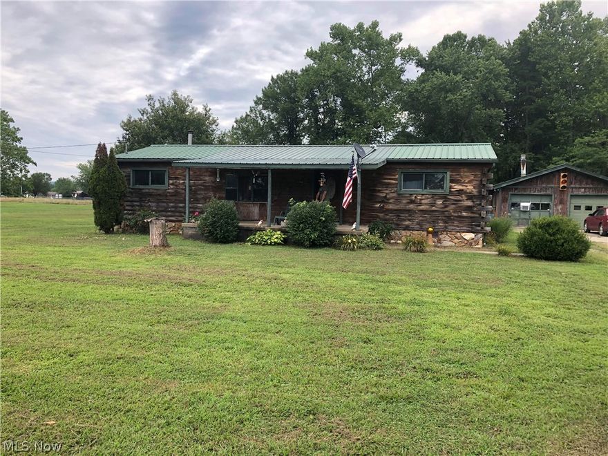 A quiet place in the country, away from the issues associated with population density. A 1100 3 bedroom 1 bath sq ft mobile home sitting on over a flat acre. Plenty of room for a garden, swimming pool, or a back yard barbeques. The mobile home has been placed on a block foundation and  upgraded with 200 amp electric, newer metal roof, solid wood log siding and a 2 car large garage. The garage has natural gas in place so a space heater could easily be add to make it nice and cozy while working  on those winter projects of your choice. There is also a large coy pond that can be refilled and returned to use for your enjoyment.  The home is well insulated and has low energy energy expenses. No worries about utilities for they are already in place.  The home is serviced with public water & sewer, natural gas, and electric. The home is value priced to reflect the work that needs to be completed to bring it up to standard. The back and deck need rebuilt, the interior needs paint and carpet.