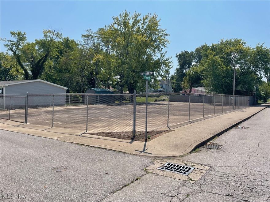 Fenced concrete parking/storage lot. Ideal for cars, boats and RV storage.