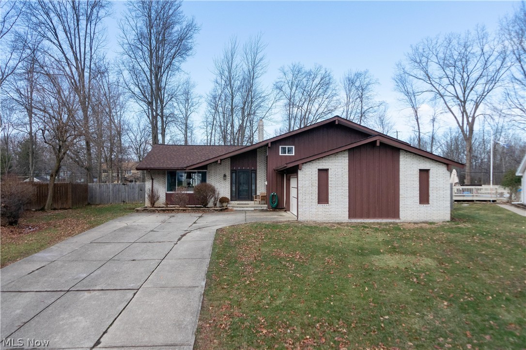 Welcome Home to 28060 Blossom Blvd. This updated and spacious 3 bedroom 2 1/2 bath split level home is ready for you to move right in! From the moment you walk into the large foyer you will love the modern colors and flow of the home. The main level features gorgeous laminate flooring, an updated kitchen with a custom-built island and stainless steel appliances as well as vaulted ceilings in the living room and dining room. The second level includes a large master bedroom with an updated full bath, 2 more spacious bedrooms, a second updated full bath, and ample closets. The lower level family room features a wood burning fireplace, an updated half bath, and a walk out to the backyard. The bonus room/laundry room leads to the 2 car garage and the basement. The fenced-in backyard (one of the largest in the neighborhood) is great for entertaining and playing and has a deck off of the dining room with a concrete patio that wraps around one side of the home. Recent updates include the roof,