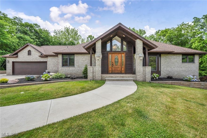 A rare opportunity in Kirtland Schools—private, resort-style living on 3.5 acres with a pool, walkout lower level, and room for everyone. Tucked away in one of Lake County’s most desirable locations, this custom-built home offers unmatched privacy, tranquil natural views, and a layout designed for both everyday comfort and unforgettable entertaining.
Step inside to a warm, open floor plan with a newly updated kitchen featuring rich wood cabinetry, granite countertops, breakfast bar seating, and direct access to an elevated deck overlooking the pool and wooded backdrop. Just off the kitchen, the dining room has been reimagined as a stylish bar/lounge—perfect for gatherings of any size.

The dramatic two-story great room becomes the heart of the home with its gas fireplace, wall of windows, and seamless indoor–outdoor flow to expansive decking.

The first-floor primary suite is a private retreat with its own balcony, a spacious en suite bath with an oversized shower, and a generous walk-in closet. A second bedroom, full bath, and main-level laundry offer true first-floor living convenience.

The walkout lower level feels like its own separate living quarters—ideal for multigenerational living, guests, or a teen suite. It includes a large recreation room, game room, two additional bedrooms, a full bath, a dedicated workout room with new carpet, and a bonus room that can serve as a fifth bedroom or home office. An abundance of storage rooms complete the level.

Outside, enjoy your own private backyard oasis: an inground pool with diving board, hot tub, stamped concrete patio, and peaceful creek views surrounded by mature landscaping. All patio furniture stays, and an invisible fence is already in place.

Homes with acreage, privacy, and full resort amenities in this school district are extremely hard to find—don’t miss your chance to make this one yours.