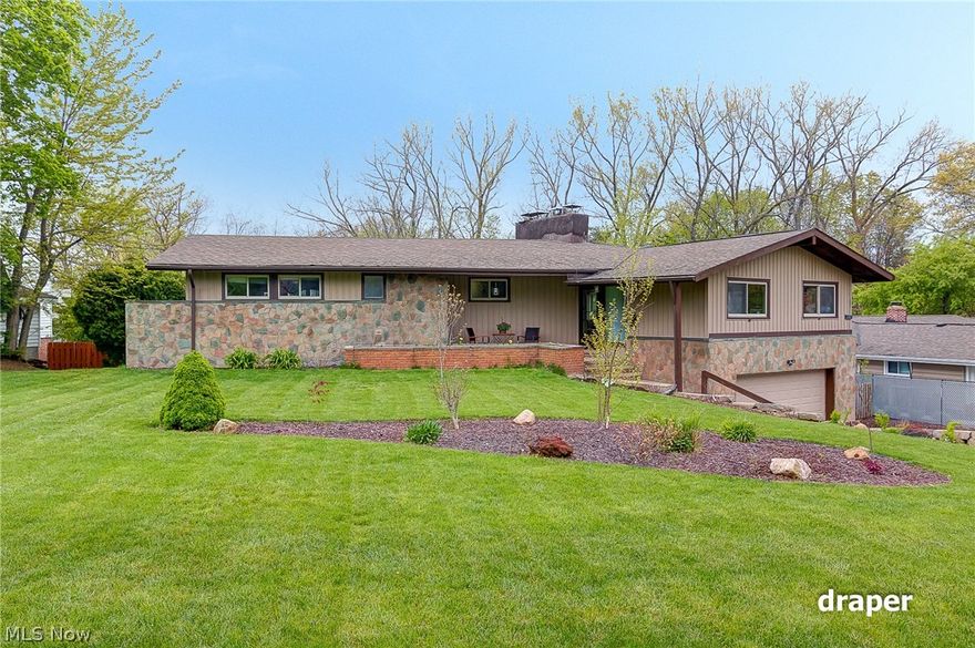 Simply - breathtaking! You will love this updated, open floor-plan home - complete with an additional  in-law or teen suite! Main floor has been opened up to showcase the beautiful views, and provide a sleek, but comfortable, contemporary feel.  Thoughtfully designed, custom gourmet kitchen is complemented by granite, warm cabinetry, and stainless steel appliances, including a wine cooler!  The island and breakfast bar overlook the great room, where the dining area is punctuated with a skylight, and the living room, showcasing a beautiful fireplace and deck access. You will appreciate how the beautiful birch hardwood flooring highlights the space! The three main-floor bedrooms also have hardwood flooring and beautiful views... The Master Bedroom is your personal retreat,  with a master bath featuring marbled walls and floor, accented with stunning blue tile, double sinks, and a walk-in glass walled spa shower. Master has double closets equipped with closet organizer systems as well! Tw