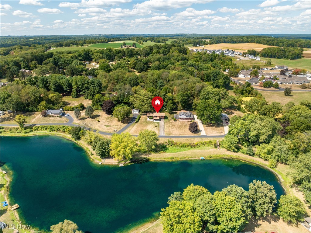 Welcome Home to Pin Oak Avenue in Jackson Township! Nestled on a private street, this beautiful lakefront home offers the perfect balance of comfort and charm. Situated on a half-acre lot, this updated split level features 4 bedrooms and 2.5 baths.
The kitchen boasts granite countertops and newer appliances, opening to a deck, where you can relax with a peaceful view of the lake. The walk-out basement is ideal for entertaining, complete with a cozy fireplace and a custom bar.
Retreat to the master suite, where a private deck provides a serene space to unwind.
Whether you're fishing, paddle boating, enjoying a good book, swimming, or picnicking by the water, this property is your gateway to lakefront living.