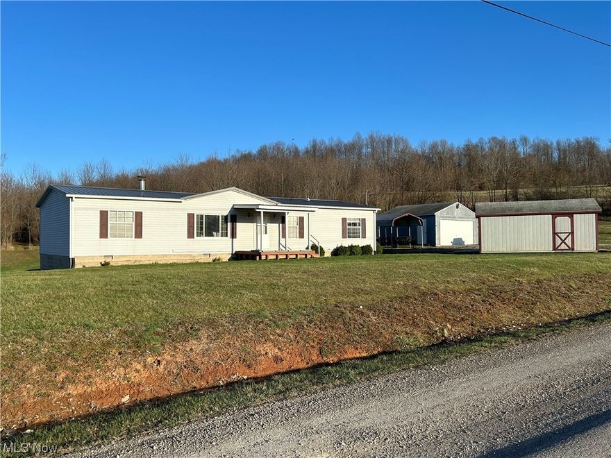 Opportunity Knocks!  Enjoy country life with this 15.352 mostly wooded acres with very well maintained, move-in ready manufactured home with concrete block foundation. This property contains a 20' x 20' garage, 16' x 20' carport, and storage buildings. The home has 3 BR 2 BA, large family room with wood burning fireplace, and new carpet in living room and owners suite. Kitchen has a brand new gas stove with built in air fryer, newer built-in microwave, dishwasher and refrigerator. New metal roof installed in 2021. Large crawl space is easy to move around in. Seller does not own mineral rights.