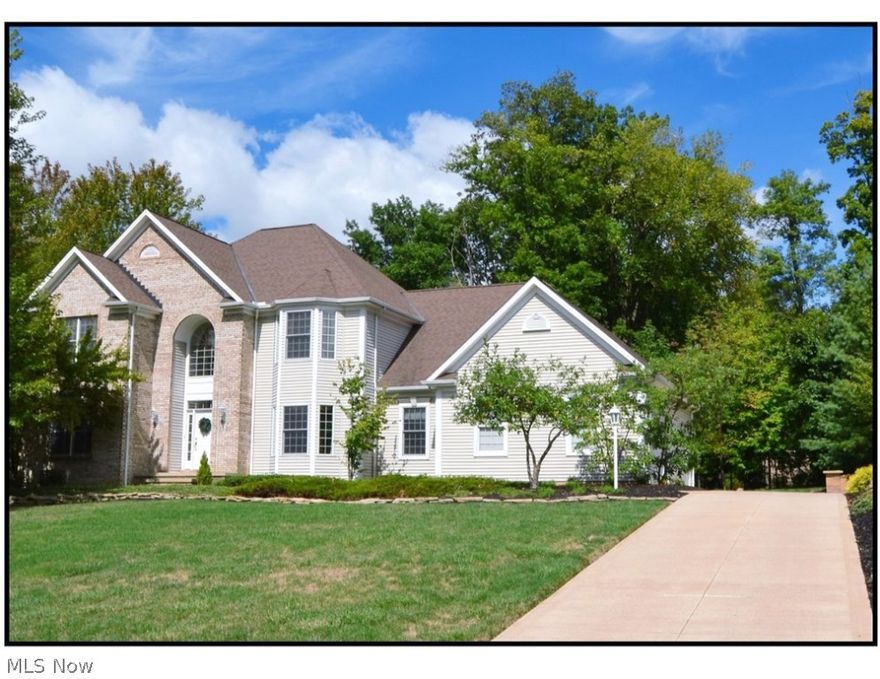 From the moment you enter the spacious two story foyer of this 2987 sq. foot home you will be greeted by a maple hardwood floor, dual closets and an open spacious feeling. There is a study, den or 5th bedroom on the main floor with a full bathroom adjacent. The formal dining room features a bayed area and sunburst design on the ceiling. As you travel down the hall you enter the gathering room with a wood or gas fireplace & a raised brick hearth.  10 foot ceilings and a triple sliding door with transom lead to the deck. The heart of the home is the kitchen featuring 42 inch graduated maple cabinets and flooring. There is also a computer desk and again access to the deck from the dinette area. A huge walk-in pantry is just off the kitchen leading towards the 1st floor laundry w/ closet, folding area and utility sink. Upstairs is the master suite complete with bayed area, spacious bath dual sinks, tub, linen closet and a 15x10 walk in closet. Three other generously sized bedrooms are on t