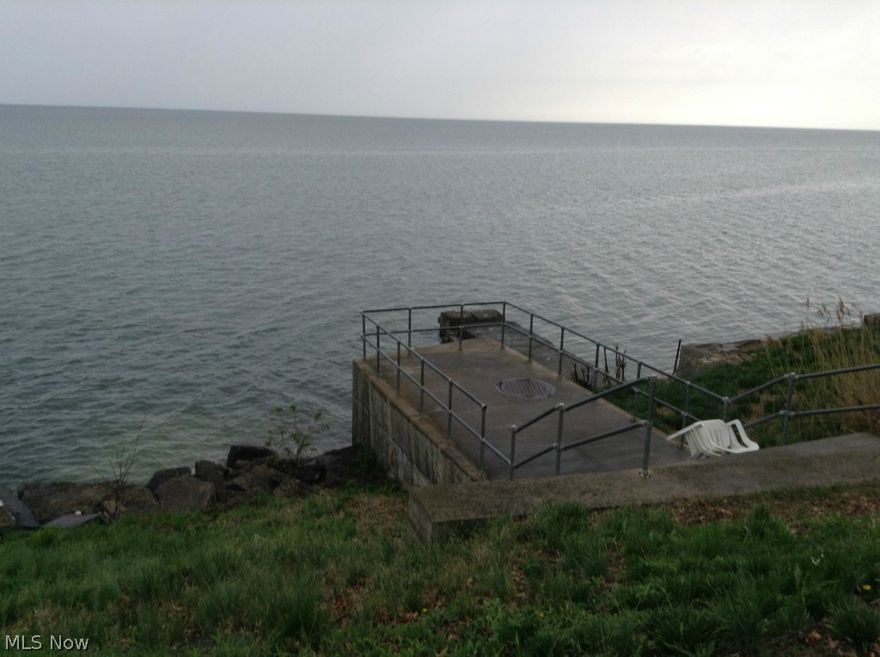 Enjoy beautiful sunsets in this lakefront home or build your dream home on this 100' x 425' wooded homesite.  There are unobstructed 180 - degree views of the lake.  It includes a breakwall with a cement pier and easy access to the water by a grass embankment.  One of the few affordable lakefront properties left with water accessibility. This is a must see lakefront property!!