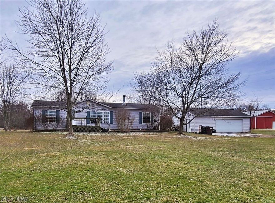 3 Bedroom 2 Bath Ranch set back on spacious 2 acre lot with full basement high ceilings and large detached garage.