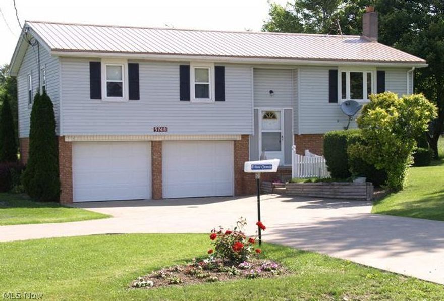 Welcome to this 3 bedroom/1 bath bi-level in Braceville Township! Large living room,  w/dining room off kitchen with newer stove & large pantry. Three bedrooms and one bath complete main floor, with storage & linen closets. Nice sunroom off dining room w/screened windows & backyard access. Basement is partially above-ground with 2 sump pumps, an electric wall heater for added warmth & access to attached two car garage. Three outbuildings on this one acre lot. to include a 16 x 20 unit w/loft (former workshop), a 10 x 12 & 10 x 10 for yard equipment. Home includes 2013 hi-efficiency Amana gas furnace & A/C, 2013 water tank & 2012 metal roof. Double thermal-pane windows are also recently updated. With reasonable offer, seller will escrow up to $15,000 towards septic upgrade if required by Trumbull County.