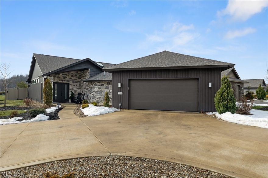 Welcome to refined ranch living in the highly sought-after Ridgefield community of North Ridgeville. Built by Bob Schmitt Homes and meticulously maintained, this residence offers a rare opportunity to own one of the newest homes in the neighborhood now that the builder is no longer constructing here.

Designed with both comfort and elegance in mind, the open floor plan showcases soaring cathedral ceilings spanning the great room, kitchen, dining area, and entry, creating a bright and spacious atmosphere. The kitchen serves as the heart of the home, featuring a large center island, upgraded cabinetry, solid surface countertops, stylish backsplash, wine refrigerator, walk-in pantry, and skylight—perfect for everyday living and entertaining.

Thoughtful updates include new light fixtures and ceiling fans, custom plantation shutters, and wood accent enhancements to the entertainment center. The primary suite offers a private retreat with a spacious walk-in closet, beautifully tiled glass shower, and professionally installed noise-canceling accent wall for added comfort.

Outdoor living is equally inviting with covered front and rear patios, the rear enhanced by skylights and a newly added private fence for added seclusion. The garage stands out with a 10-foot ceiling, finished flooring, hot and cold water, floor drain, overhead storage access, and service door to a second patio.

Additional highlights include a sprinkler system, tankless water heater, and oversized turnaround driveway. The cluster home maintenance fee covers landscaping and snow removal for low-maintenance living. Residents enjoy access to a clubhouse, fitness center, Olympic-size pool, and children’s pool, all conveniently located near shopping, dining, parks, and major routes.

This move-in-ready home delivers the quality, upgrades, and feel of new construction without the wait.