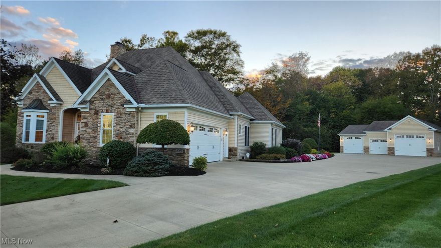 The secret is out – Garrettsville is a wonderful community! Restaurants, coffee shops, a movie cinema, grocery stores, all set within a scenic and historic area of Portage County. Often thought of as “too far away” from the bright lights and big cities, this gem of a community is just 30 minutes from Solon (with easy access to route 422) and Twinsburg (a straight drive via route 82). Best of all, you won’t have to give up indoor plumbing! While developers Becky and David Harrington are often associated with developing Middlefield (there would not be a Walmart and the plazas off Harrington Way if it not for them), they were also creating the beautiful cul-de-sac street and selecting the choice location for their estate overlooking the scenic confluence of Eagle and Comp Creek. Becky certainly had an eye for a great floor plan and tasteful décor. Her vision of a home was brought to life in what may be the nicest home in Garrettsville. The moment you walk into this ranch with a walk-out lover level you will realize this is no ordinary home. Ceilings over 13’ high, black walnut surrounding the fireplace, hardwood flooring, and too much more to list. The lower level features a wet bar/soda fountain with seating, a media room, an exercise room, and a large entertainment area with access to the lower-level covered patio. The pictures do not do this property justice; it’s a home you need to experience in person. As particular as Becky was of the home, Dave was just as particular for the garage- which at one time was a museum of Dave’s need for speed and ties to history. The drag racer, motorcycle, pristine stake bed truck, and other vehicles have been removed. It is a CAR COLLECTOR or HOBBY SHOP DREAM. Radiant floor heating, 3 front facing bays with overhead doors, a half bath, as well as a rear bay with overhead door. Room for at least 10 vehicles – RV’s, ATV’s, Boats, or your 1965 Mustang convertible. Backup generator will power home and garage. ADJOINING LOT AVAILABLE.