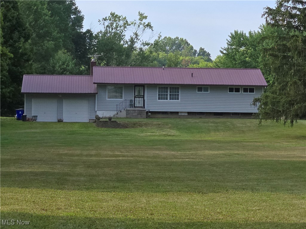 Rootstown Ranch home situated on almost 2 acres. Home sits far back from road for a sense of privacy. There are 3 bedrooms and one full bath on the main level. Large eat-in kitchen. A spectacular wall of windows in the living room and dining room overlooks the secluded back yard. Hardwood floors throughout most of the first floor. Central A/C. Walk out basement that is plumbed for a second bathroom. 2 car garage that is attached to home, but outside access to home. Seller is selling home in as is condition. Bring your own finishing touches to make this your home.