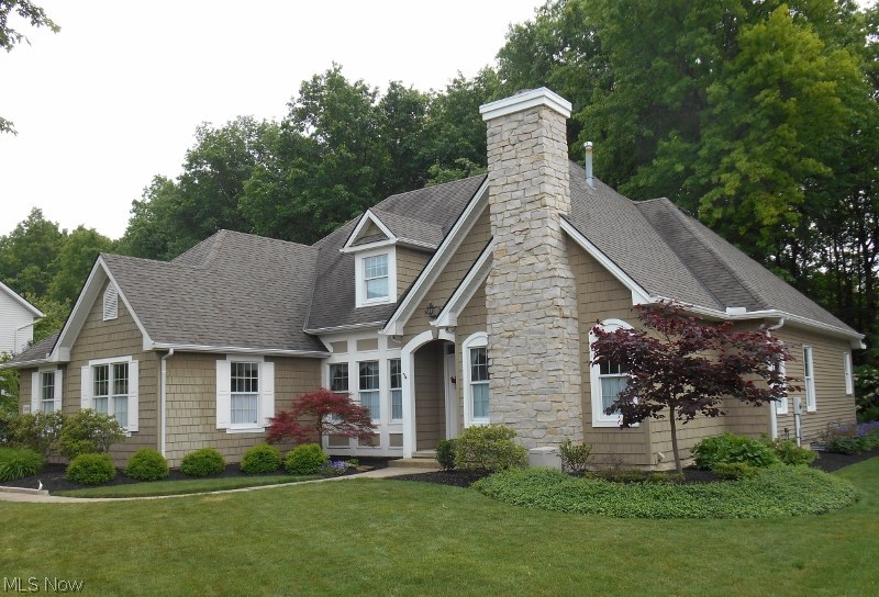 A unique, one of a kind, cottage style home is located on a beautiful 1/2 acre wooded lot backing on the Miller Nature Preserve. This home offers a peaceful retreat while being accessible to I90, Avon Commons, and other local attractions. The Cape Cod original design compliments its natural surroundings with a Lake Erie gray limestone chimney, cedar shake shingles, and stone patio and walks leading to a hydrangea draped arbor. Inside, the foyer sparkles with sunshine washed through leaded imported glass sidelights and transom. The home has four bedrooms with a master on main, finished in place hardwood floors, exotic granite, one stone fireplace and one antique fireplace. The overall feeling of quality continues with Anderson windows, premium trim package, large walk in pantry, oversized two car garage, and partially finished basement with full bath accessed from two staircases. This home cannot be found anywhere else in Avon. Call for an appointment today!