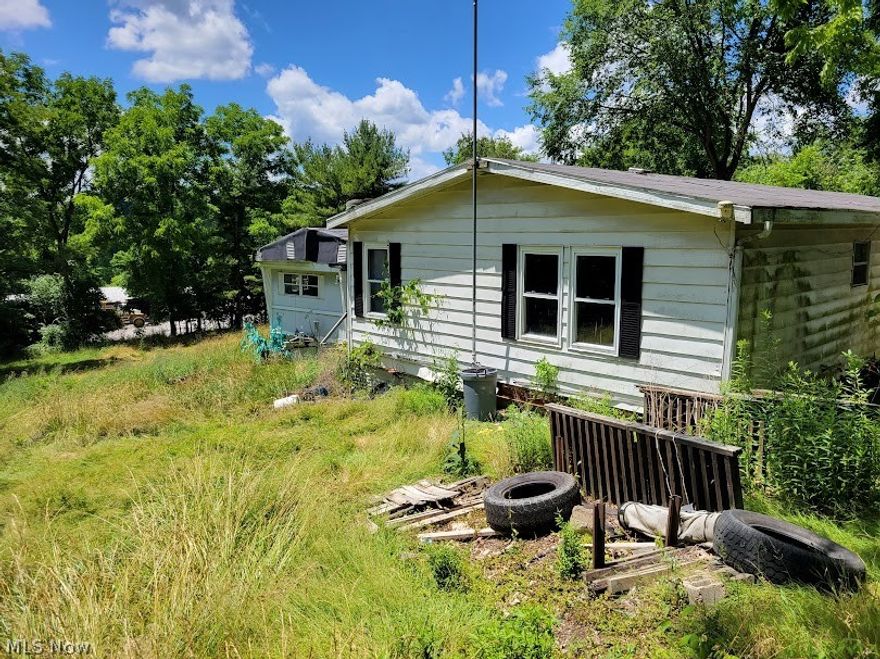 A Beautiful piece of land outside city limits where it is quiet and Peaceful.  Slightly under 1 Acre.  Minerals rights / royalties are included with the sale.  There is a modular and a mobile home both attached to the land.  The separate Mobile home is 1972 Skyline and is attached.  Square feet of separate mobile home is unknown.