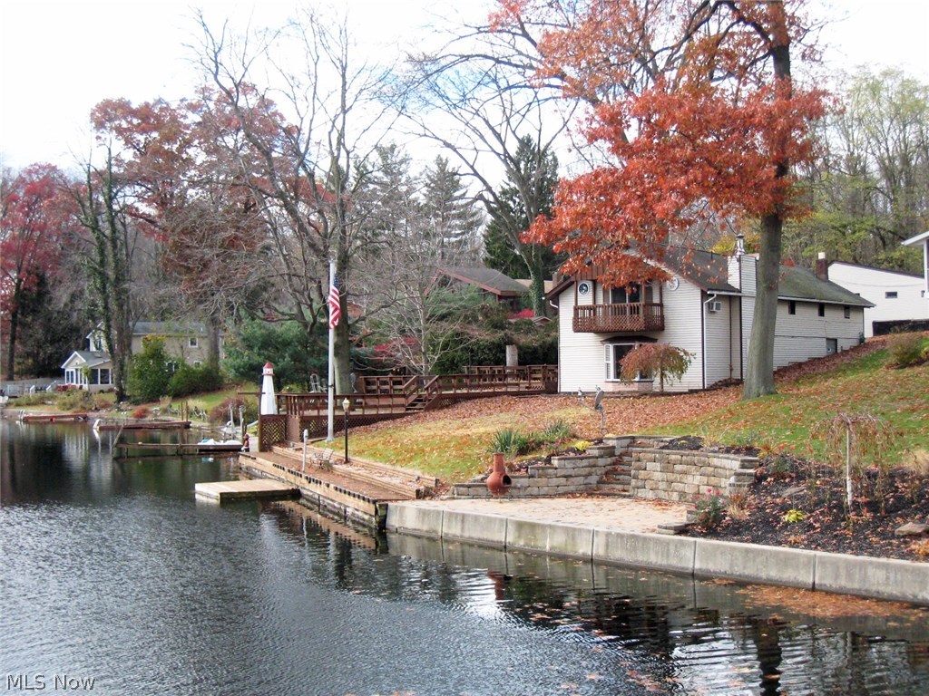 Tired of looking at tiny homes in Portage Lakes? This lake home has all the space you'll ever need and more with a four car garage and plenty of off street concrete parking. This home has over 2600 SF! The indoor and outdoor spaces are perfect for large groups with the huge 3-tier deck overlooking the water! Spacious rooms throughout the home. Large living room features American gas burning stove and a large bay window with views of lake. Large master bedroom 20x24 with private master bath, walk-in closet, and a private balcony overlooking the water. Over 60' of lakefront with a planked walkway along the water which is 3'-4' deep, perfect for docking multiple boats without getting into weeds! Don't miss out! Call today to schedule your showing!