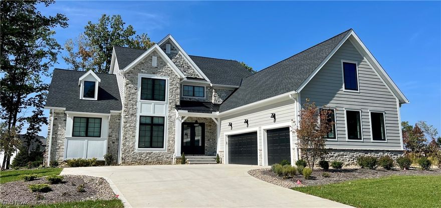 Welcome to this Incredible fully landscaped New home in the Stunning gated community Barrington Estates! One of the premier developments in Cleveland. Gorgeous Move In Ready home with first floor owners suite and First floor mother in law suite with its own full bath! All the luxury amenities you could want. The Stunning Kitchen boasts Kraftmaid cabinets, Kitchenaid Appliances with 36" professional gas Range, large panty and a wet bar. Huge 2 story living room with a touch screen controlled fireplace. Top Quality Pella Impervia Windows, Super efficient Carrier 2 zone heating and cooling with first and second floors independently controlled.. The first floor owners suite is spacious with stunning wood beams, Heated Tile in the master bathroom for those cold winters!!! The master closet is massive and has custom shelving. The kids bedrooms upstairs are all very large. The three car garage has a professionally installed Polyaspartic floor, gas heater and a 220 plug for an electric car! Huge finished basement with 9 foot ceilings, a gym and half bath. Award winning schools, an incredible gated community and a hard to beat floor plan. Move in Ready!!!