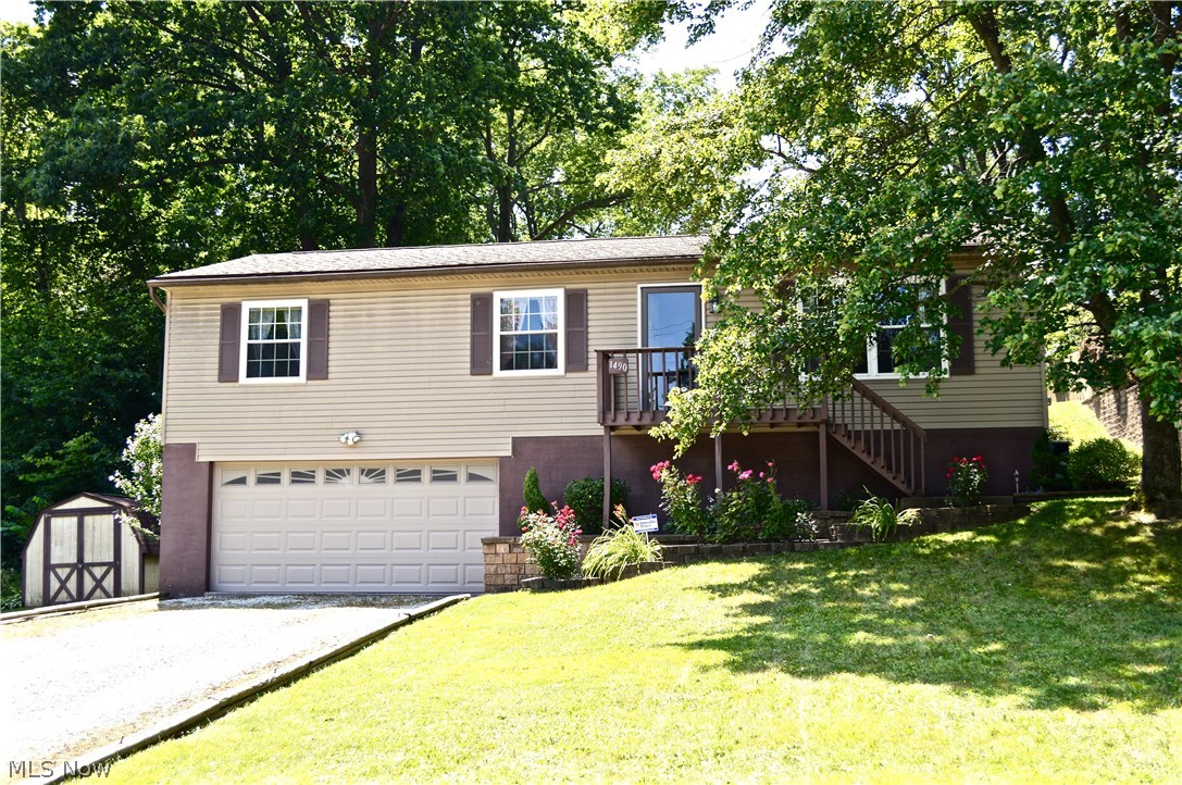Welcome home to this move-in ready raised ranch nestled on a large wooded lot! Spacious and bright Living Room, 3 Bedrooms, Full Bath, and Kitchen are all conveniently located on main level. The updated eat-in kitchen features newer cabinets, counters, stainless steel appliances, and floor. Walk out the new sliding glass door to a huge 30'x16' two-tier deck and beautifully landscaped backyard that is perfect for entertaining. The lower level features a spacious family room, large utility room, generous storage areas, and room for a potential second bath. Attached oversized 2 car garage and 2 exterior sheds provide ample storage. Recent updates include: siding, windows, slider, garage door, insulation in attic, hot water tank, fresh paint, and more! Furnace in 2010, Roof replacement in 2006 with newer gutters and leaf guard. Just move in and enjoy! Great location with easy highway access and close proximity to Meadowbrook Lake, parks, and shopping. Call today for your private showin