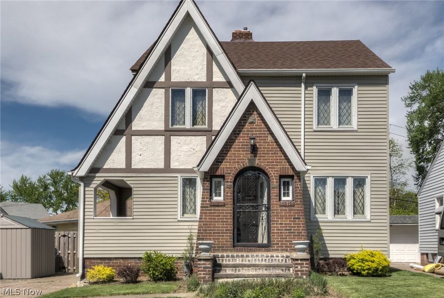 Charming three bedroom Tudor-style colonial in the heart of Parma Circle! Lots of great updating including plumbing, electrical, furnace, and completely remodeled kitchen and baths. Don't miss the vestibule entrance or the charming formal dining room with upgraded lighting, built-in leaded glass cabinets, refinished hardwood floors and crown molding. There is also a convenient first floor half bath and a covered side porch. Upstairs features a master bedroom with a huge walk-in closet, plus two other bedrooms and stairs to an unfinished attic. The basement has an unfinished recreation area plus laundry/utility room. Welcome Home!