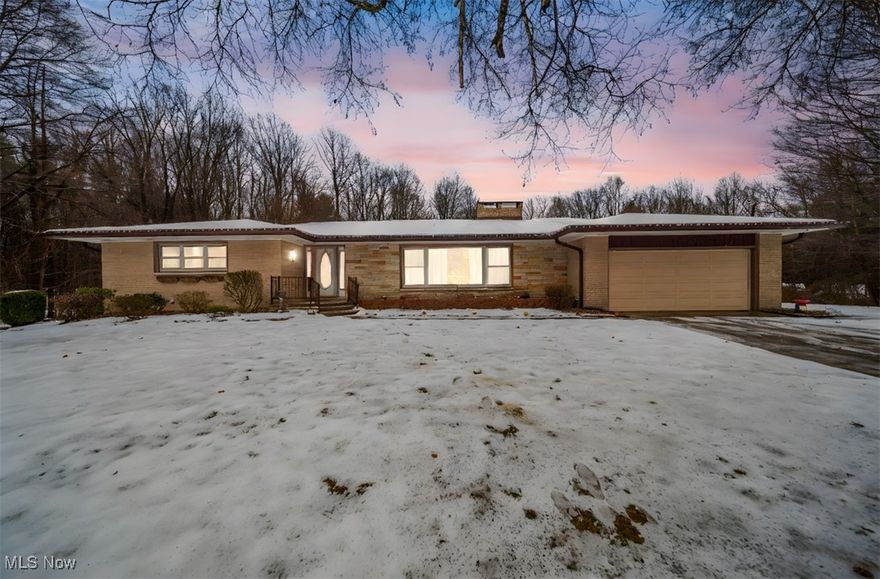 Looking for privacy while still staying close to Lake Erie and all the nearby conveniences? This charming 3-bedroom, 1.5-bath brick ranch offers the perfect balance of seclusion and accessibility. On 2.38 acres with just under 2,000 sq. ft. of comfortable living space and located in the Buckeye Local School District, this home checks all the boxes.

The welcoming foyer opens into an oversized living room accented by a stunning stone fireplace—an ideal spot to relax or gather with guests. The kitchen has been beautifully updated and features warm oak cabinetry, a roomy pantry, and plenty of counter space. It flows into a spacious dining area large enough to host everyone for holidays or weekend dinners.

Two generous bedrooms sit at one end of the home, each with impressive closet space—either could easily serve as the primary. Throughout the home you’ll notice rich solid-oak doors and trim that add timeless character.

The partially finished basement provides even more flexibility, complete with a second fireplace, hobby/workshop areas, and newer glass block windows that bring in natural light while adding security.

Outside, the backyard is its own private escape. A large deck with a above-ground pool, which comes equipped with solar panels for heating and a full filter system, all staying with the home. It’s the perfect setup for pool parties or quiet lounging, with wooded surroundings on both sides offering extra privacy. And for a special bonus—during the winter months, you can enjoy a peek-a-boo view of the lake.

Additional updates include new deck, a new septic system installed in 2022, basement was waterproofed and french drains were installed in 2023 as well as new 6 inch gutters in 2022. All appliances are included, making this home truly move-in ready.

Don’t miss the chance to make this spacious and well-cared-for ranch your own!