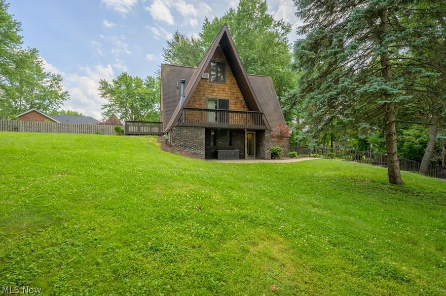 If you're looking for a unique home to call your own look no further! This is a nature lovers dream with lots of beautiful outdoor entertaining space. The home features a in-ground stone pool with beautiful landscaping surrounding it. Extra deep two car garage has a chain link fence off of it perfect if you have pets. Both bedrooms feature their own private balcony/porch and both living rooms have sliding glass doors for outdoor access and natural lighting. Top level can be used for additional living space or a 4th bedroom. Nothing but tranquility at this double A frame in Rootstown Township! Just minutes from Lake Hodgson (can be seen in photos), NEOMED, and I-76. Don't miss out on this one!