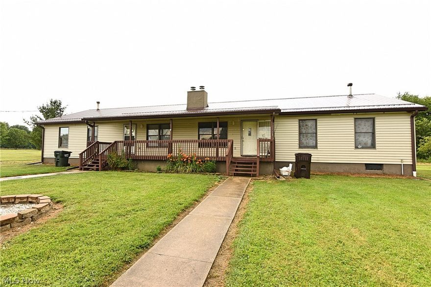 Meticulously maintained duplex located in a country setting in the James A. Garfield school district.  Each unit contains 3 bedrooms, 2 full bathrooms, and a full basement underneath.  Laundry for each unit is located in the individual basements.  Each basement has been finished some, one more so than the other.  This property also contains a recently vacated 48' X 38' garage.  The garage has a roll-up door on each 38' side of the building and is partitioned in the middle.  the garage rented for $500.00 per month from 03/2020 to 03/2021.  Can easily be made to rented per side or used for personal use.  New metal roof and gutters on duplex and garage in 2020. New metal siding on garage in 2020. New sump pump and hot water tank in both units in past 3 years. New footer drains. This property is turn-key for either an investor or someone who would like to live in half and rent the other.