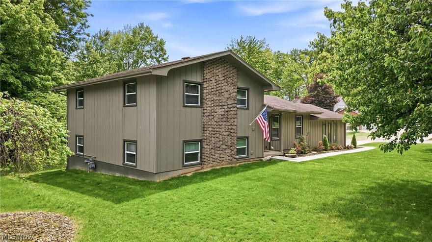 This fully remodeled split-level home at 485 Grandview Avenue, Hubbard, Ohio 44425 offers timeless mid-century charm. From the moment you enter, you’ll appreciate the soaring vaulted ceilings, exposed beam detail, luxury vinyl plank flooring, and the bright open-concept design that creates an inviting atmosphere throughout the main living space. The spacious living room flows seamlessly into the dining area featuring updated lighting fixtures, vinyl windows, and all new interior and exterior doors giving the home a clean, modern feel. The beautifully updated kitchen is designed to impress with white soft-close cabinetry, granite countertops, subway tile backsplash, recessed lighting, and stainless steel appliances. Convenient access to the rear deck allows you to overlook the backyard while creating the perfect space for entertaining or relaxing outdoors. Upstairs offers 3 generously sized bedrooms with newer carpet, great closet space, and updated fixtures throughout. The primary bedroom provides direct access to the fully remodeled bathroom complete with tiled tub surround, updated vanity, and modern flooring. The lower level adds exceptional additional living space with a cozy family room featuring new drywall, carpet tile flooring, and sliding door access to a stunning flagstone patio area. This level also includes a beautifully updated full bathroom with a tiled walk-in shower, updated vanity, and vinyl plank flooring. The basement level provides endless possibilities for future finishing while currently offering a laundry area, abundant shelving and storage space, updated HVAC system, hot water tank, 200-amp electrical panel, and walk-out access to the attached 2-car garage complete with updated lighting and additional storage. Outside, the property continues to impress with an additional 24x30 detached garage featuring a pass-through garage door and attached lean-to, making it ideal for a woodshop, hobby space, extra parking, or outdoor entertaining area.