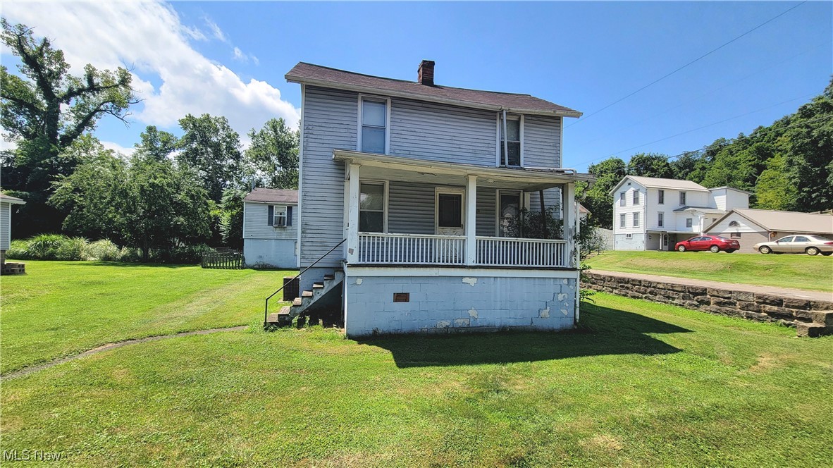 This corner lot in the historic West Side of Marietta has a large, level lot, 2 housing opportunities, and off-street parking. The main house has 2 bedrooms and a bathroom upstairs. There is an eat-in kitchen with laundry and a half bathroom, a living room, and a den, which was once used as a first floor bedroom with a shower. What was once a garage is now a second home with first floor family room and second floor kitchen, full bathroom, 2 bedrooms, and a living room. There is a fenced area off the 2nd home for 4 legged friends. Ever wanted a house with a moat? Well, this is close. While it is in the flood plain, the ditch or drainage system helps remove rain water from directly around the house (and it's pretty cool to look at). House being sold as is.