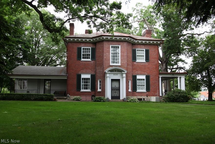 This 2-story Italianate brick house constructed by William Curtis in 1871 is located in Zanesville' s National Historic Mcintire Terrace District. Situated on a tree covered, .68 acre corner lot with brick lined streets and brick sidewalks. Quick access to Interstate 70 makes for easy commute to Columbus. The house was extensively remodeled in 1920, moving front entryway 180 degrees, among other renovations. The remodeling was done in a Neo-Classical fashion. The original 4 bedroom home was converted to a 3 bedroom in 1992 when one bedroom was converted to a walk-in closet with French doors, creating a master suite. Other enhancements include updated main bathroom and kitchen, central air conditioning, first floor laundry with plenty of storage, and three and one-half car detached garage with paved through-driveway. While updated it still has maintained its original charm, featuring oak hardwood floors; 2 story foyer with large brass chandelier; original fireplaces; crown molding and l