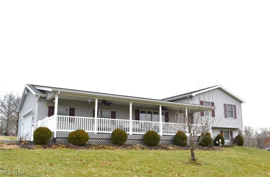 MECHANIC'S DREAM!  Rare offering that doesn't come along often! 9 year young home situated on 1.4 acres that features a generously sized detached 3 bay garage complete with hydraulic car lift, central heat and air, loft and commercial refrigerator.  Plenty of storage room for all of your hunting gear, ATV's and great area for a workshop.  The home offers spacious rooms complete with oak kitchen and island, master bedroom with master bath and finished recreation room with wood stove.  Other extras include an additional attached 2 car garage (that's 5 car garage total!), metal out building, french doors off kitchen to large deck and updated main bath.